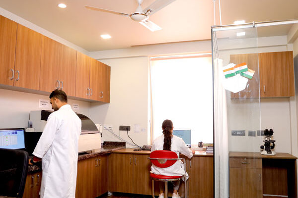 Pathology laboratory at Health Quest Imaging & Diagnostics with trained lab professionals performing diagnostic testing using advanced laboratory equipment in a modern workspace.