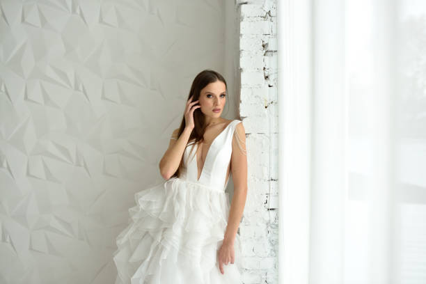 Portrait of a beautiful bride close-up on a white background. Portrait of a beautiful bride close-up on a white background. Milanova Bridal dress stock pictures, royalty-free photos & images