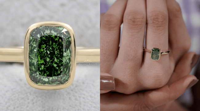 Close-up of a green lab grown diamond engagement ring featuring a radiant-cut green diamond in a yellow gold bezel setting shown on a finger.